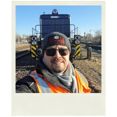 SOL TRAIN Mitarbeiter im Selfie vor einer Rangierlokomotive im Bahnhof
